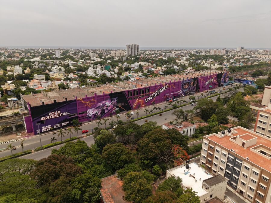 The Campa Energy mural with the wear-seatbelt road-safety panel, race car and UNSTOPPABLE lettering